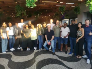 A large group of EY employees smiling for a team photo during their team building activities year-end function at Adega Norwood