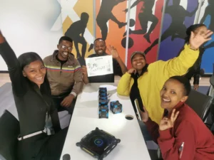 The "9 Life Gang!!!" team from Merchants smiling for a photo during a team building activity held at their offices