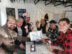 A cheerful group from ProPay holding up team building challenge cubes and a team sign during an event at the Tres Jolie venue