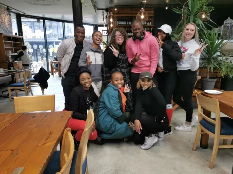 A diverse group of men and women from the VAT IT team posing and smiling for a group photo during a team building event in Norwood, Johannesburg